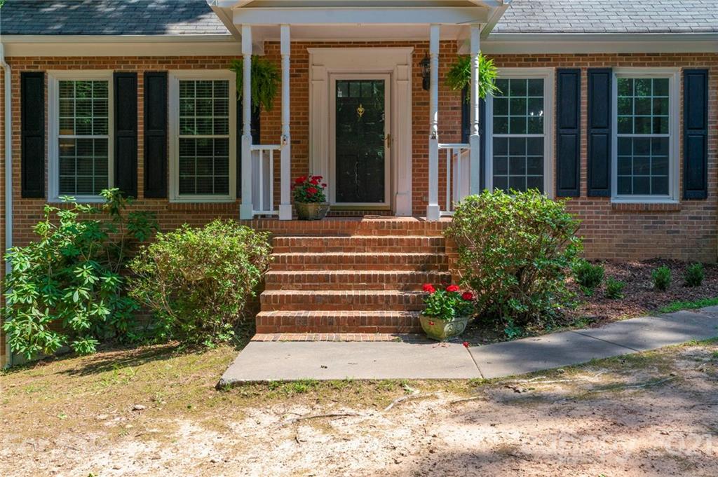 224 Raintree Drive Matthews, NC 28104 - Photo 2 of 48 a view of a house with potted plants