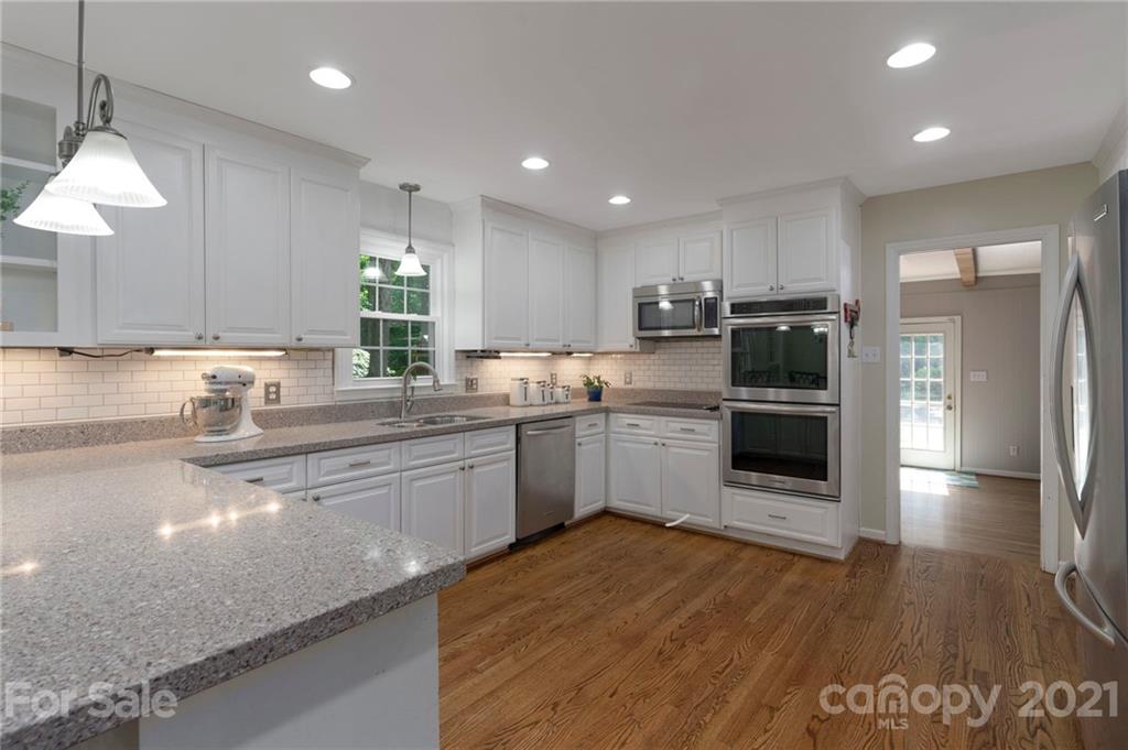 224 Raintree Drive Matthews, NC 28104 - Photo 17 of 48 a kitchen with a refrigerator a sink a stove a microwave and cabinets