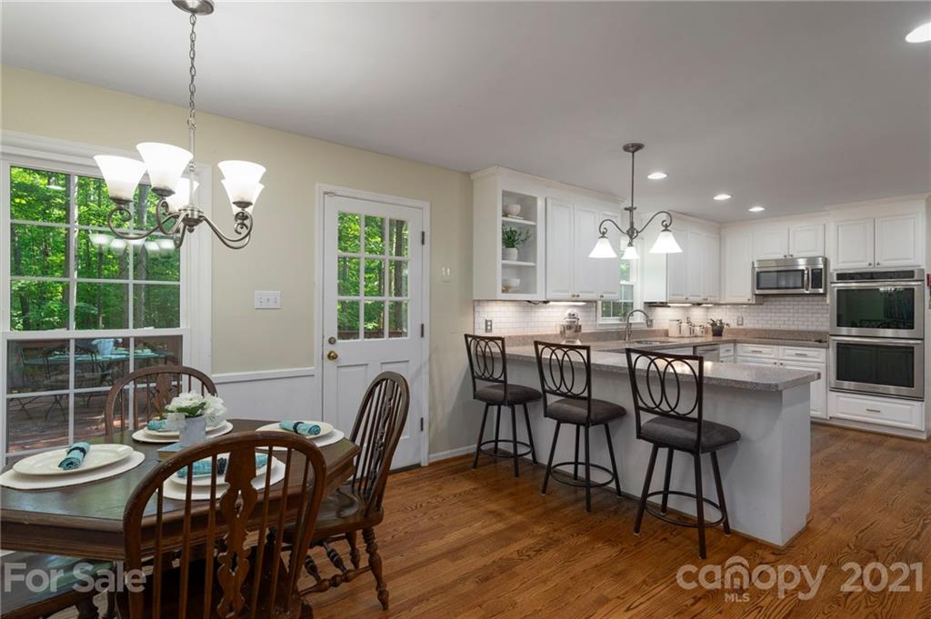 224 Raintree Drive Matthews, NC 28104 - Photo 19 of 48 a dining room filled chandelier and wooden floor