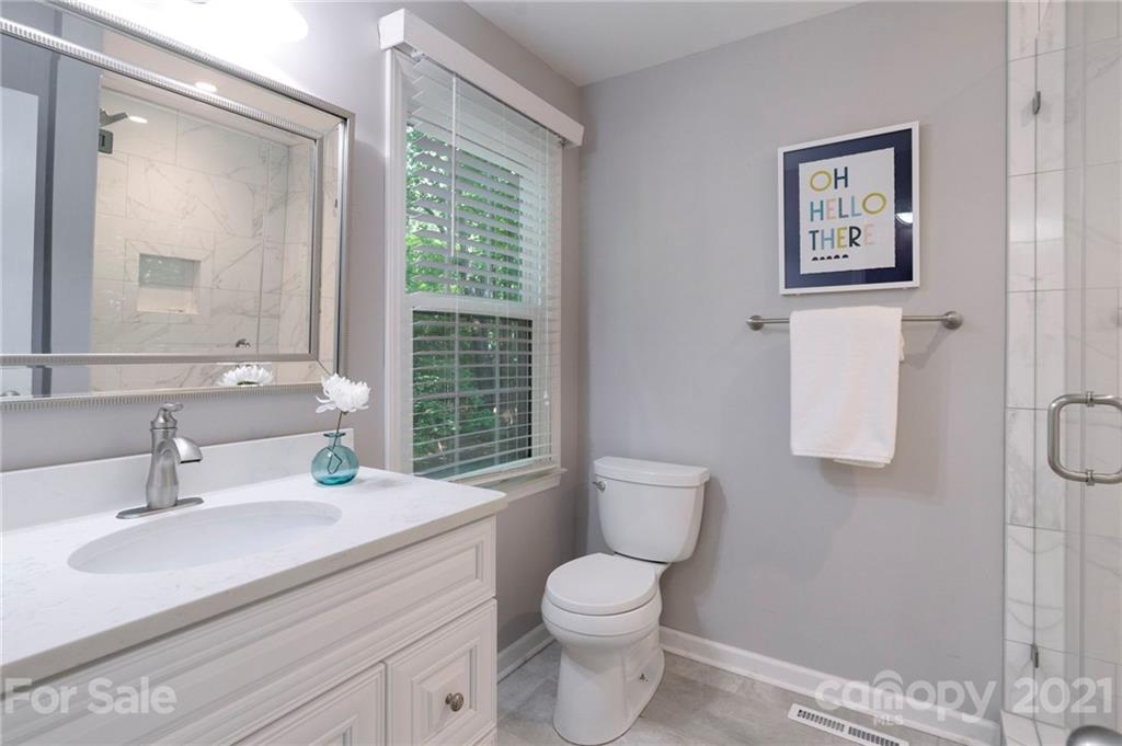 224 Raintree Drive Matthews, NC 28104 - Photo 24 of 48 a bathroom with a toilet sink and mirror