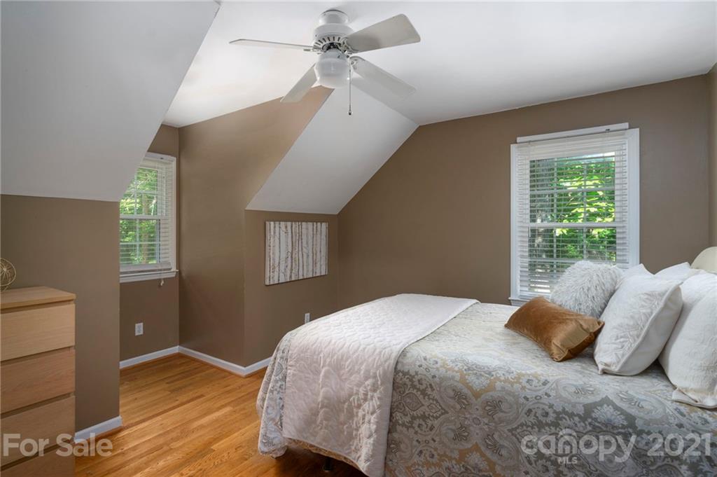 224 Raintree Drive Matthews, NC 28104 - Photo 25 of 48 a bedroom with a bed and wooden floor