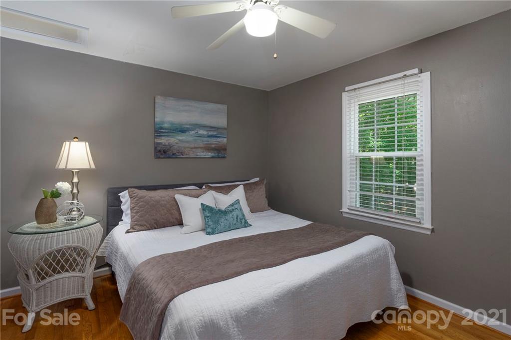 224 Raintree Drive Matthews, NC 28104 - Photo 26 of 48 a bedroom with a bed and a lamp