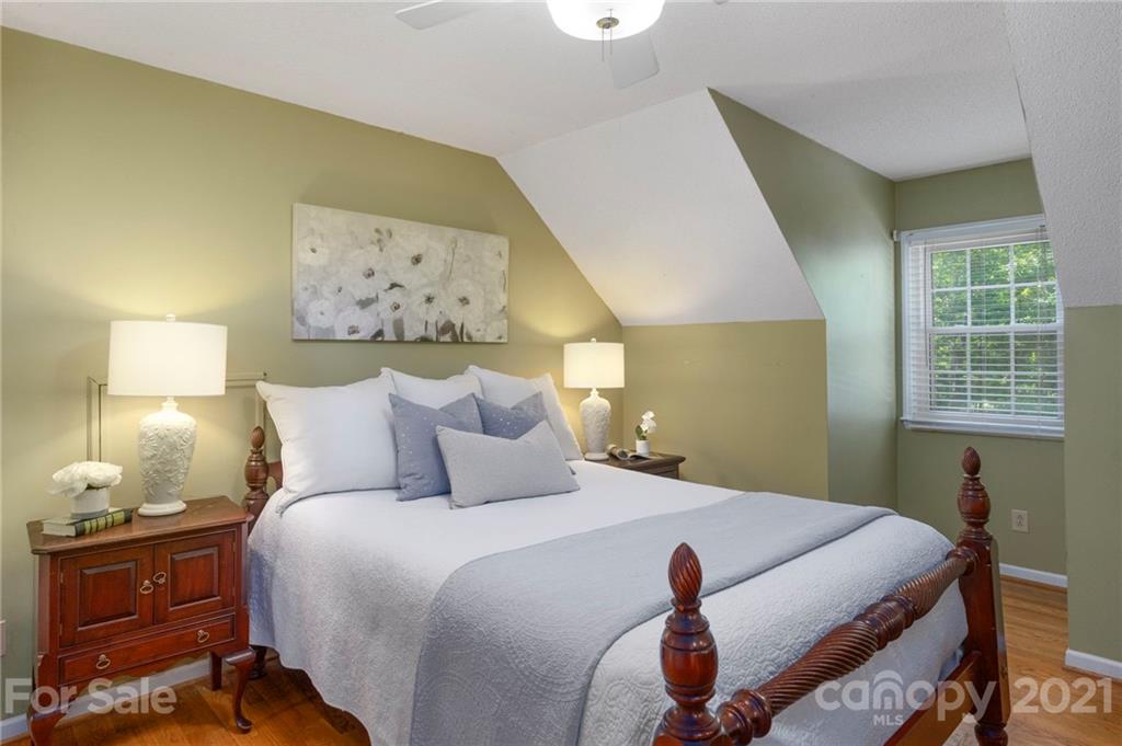 224 Raintree Drive Matthews, NC 28104 - Photo 28 of 48 a bedroom with a bed and wooden floor