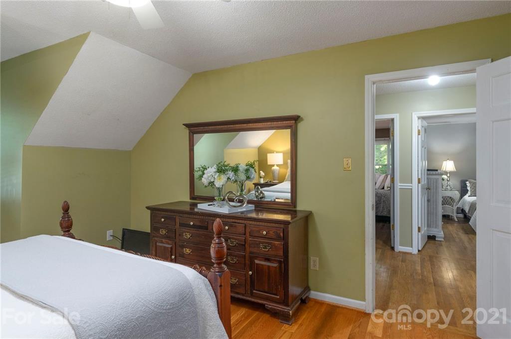 224 Raintree Drive Matthews, NC 28104 - Photo 31 of 48 a bedroom with a bed and a table in it