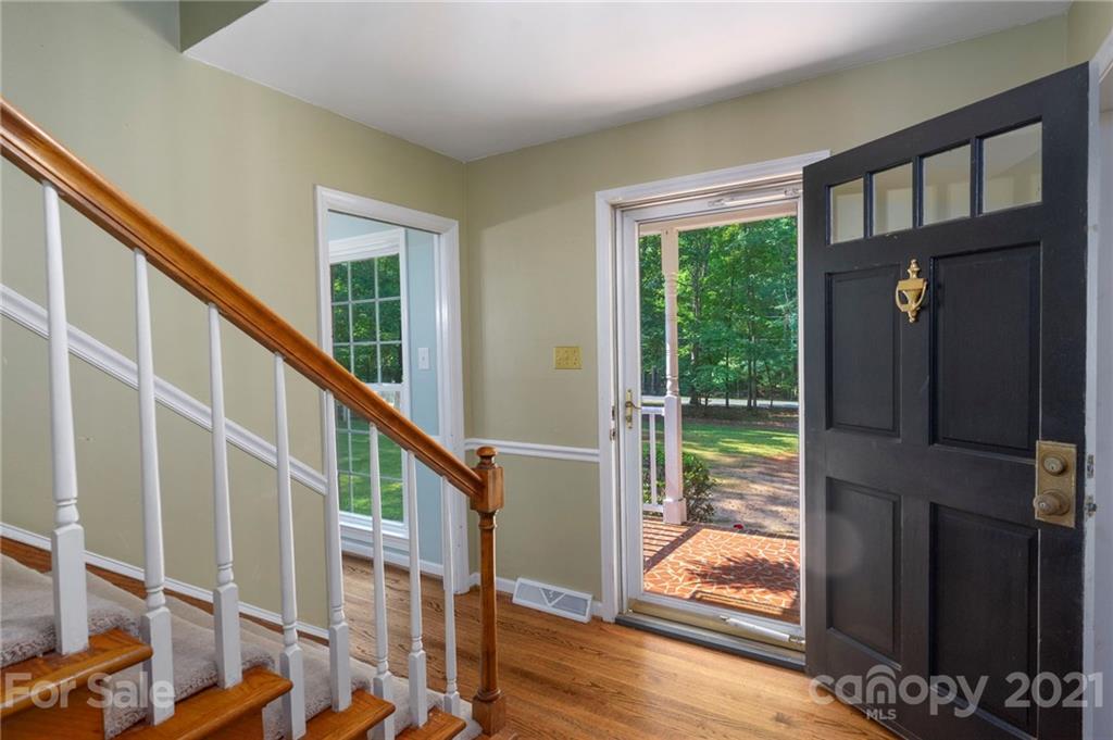 224 Raintree Drive Matthews, NC 28104 - Photo 7 of 48 a view of entryway with wooden floor and door
