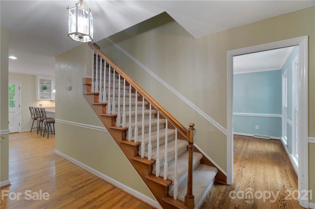 224 Raintree Drive Matthews, NC 28104 - Photo 9 of 48 a view of entryway and hall with wooden floor