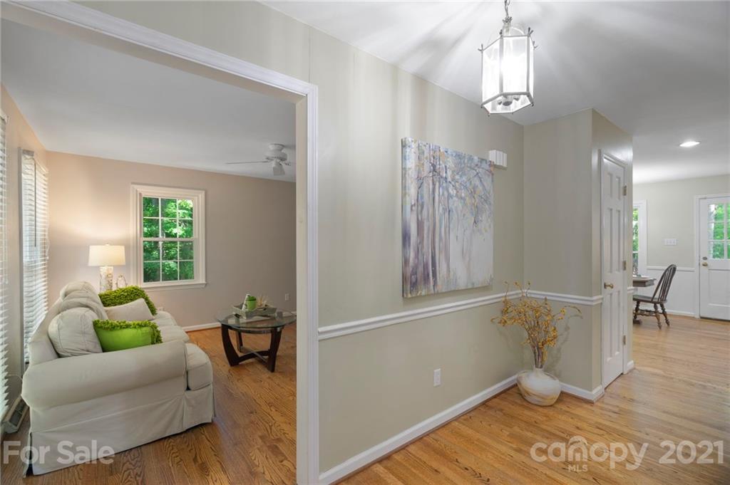 224 Raintree Drive Matthews, NC 28104 - Photo 10 of 48 a living room with furniture and a chandelier