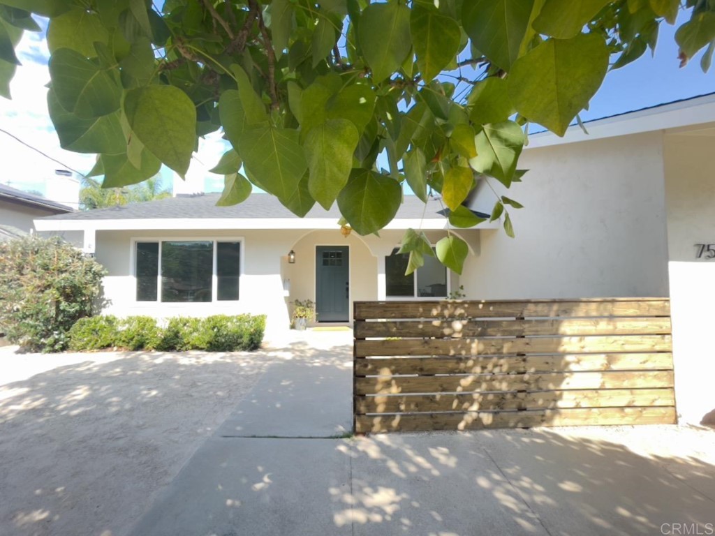 7530 Conestoga Way San Diego, CA 92120 - Photo 1 of 14 a front view of a house with a yard and a garage