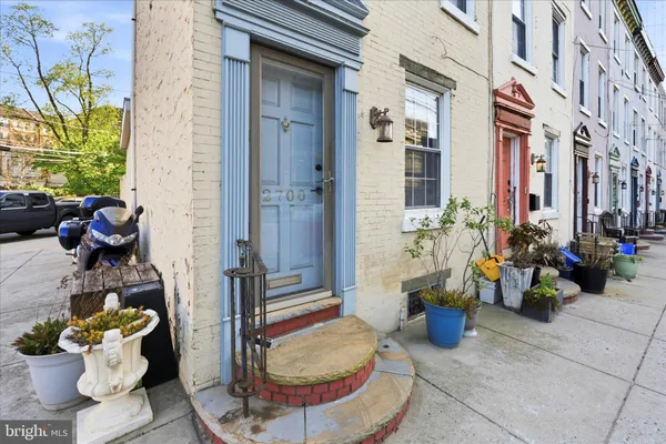 a view of a patio with dining table and chairs potted plants