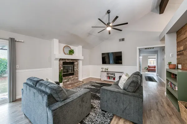 a kitchen with stainless steel appliances a dining table chairs and refrigerator