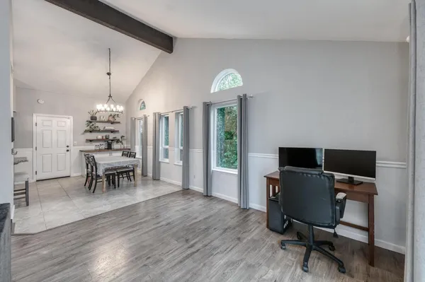 a view of a dining room with furniture wooden floor and chandelier