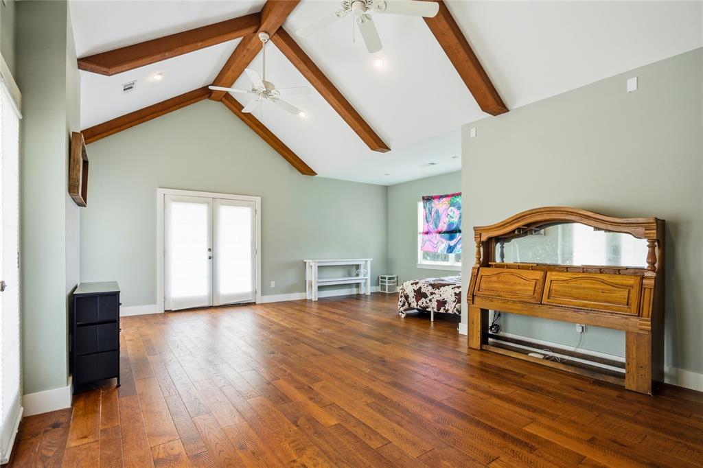 1073 Gordonville Road Gordonville, TX 76245 - Photo 26 of 38 Bedroom 3 is a huge room that has two usable spaces for beds and dressers. Double doors on each side lead out to a wrap-around balcony with gorgeous view. It's a great place to sit and relax in the serenity of this property.