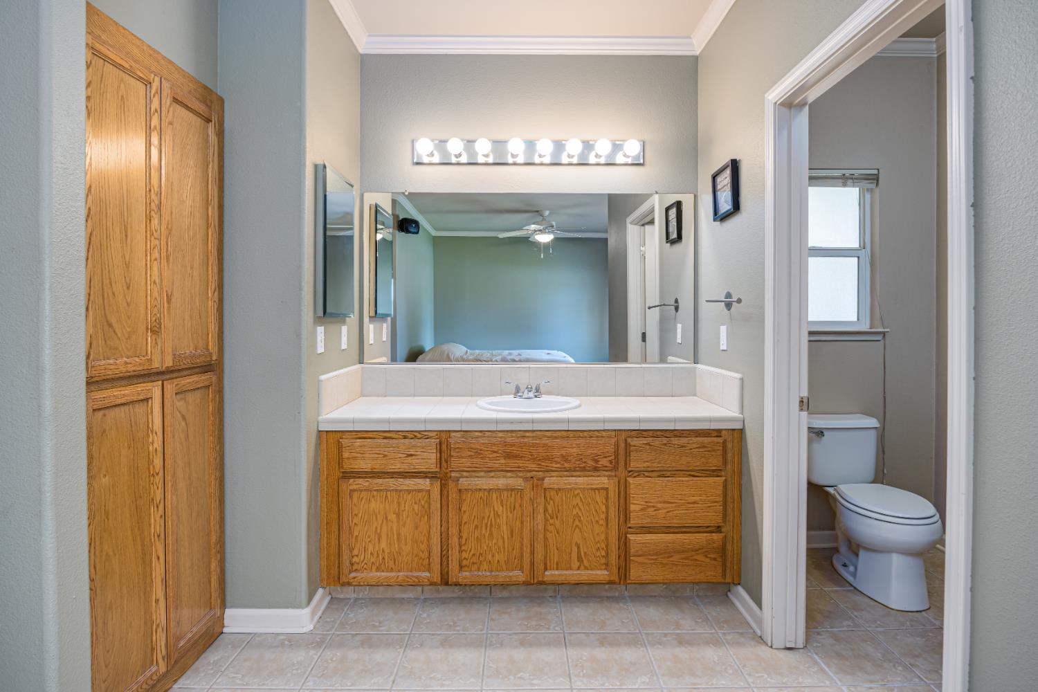 2083 State Rte 26 Valley Springs, CA 95252 - Photo 20 of 59 a spacious bathroom with a granite countertop sink a toilet and a mirror