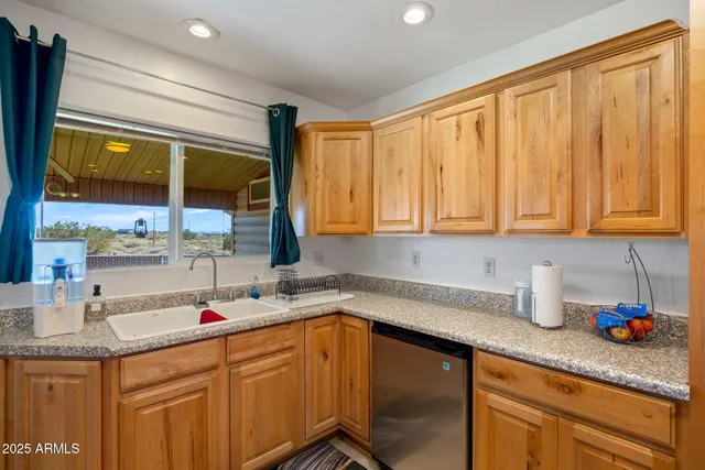 a kitchen with stainless steel appliances granite countertop a refrigerator a sink and a stove