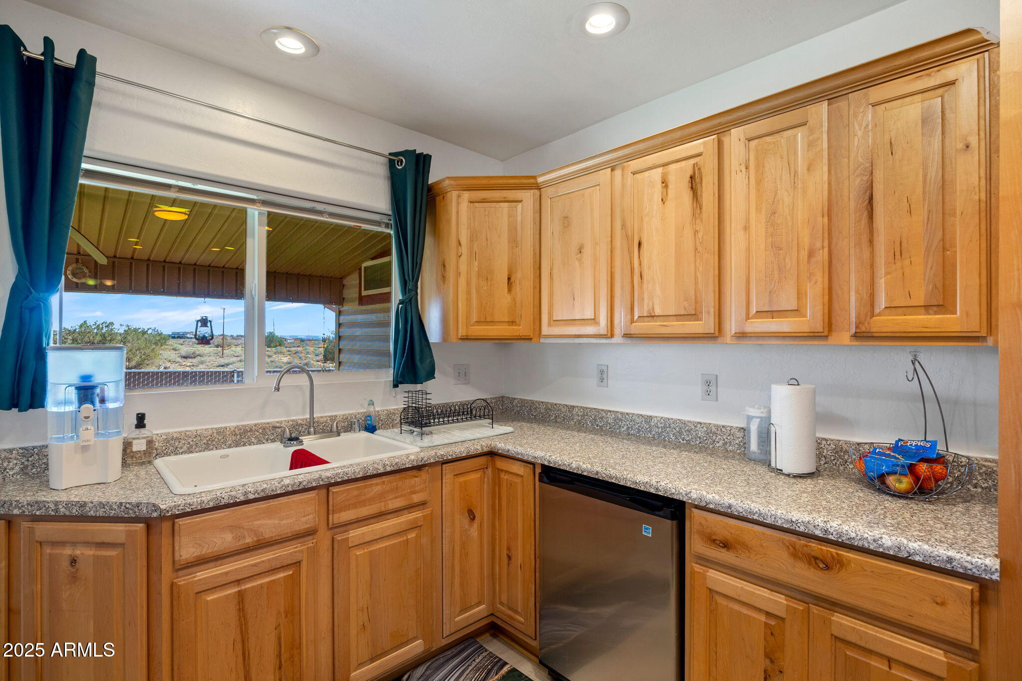 1689 Eager Avenue Snowflake, AZ 85937 - Photo 13 of 45 a kitchen with stainless steel appliances granite countertop wooden cabinets a sink and a large window