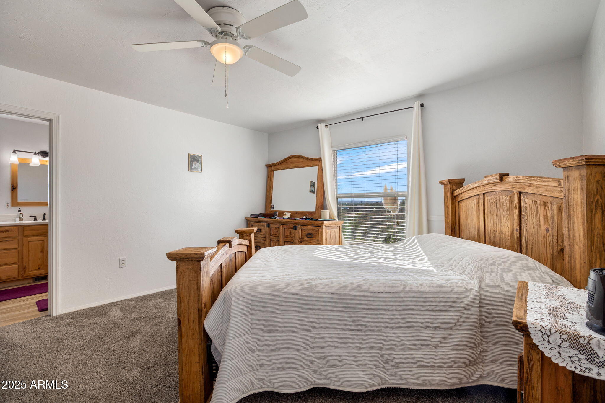 1689 Eager Avenue Snowflake, AZ 85937 - Photo 15 of 45 a bedroom with a bed and a chandelier