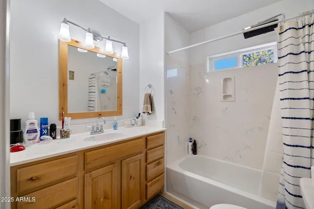 a bed room with a bed mirror and a night stand