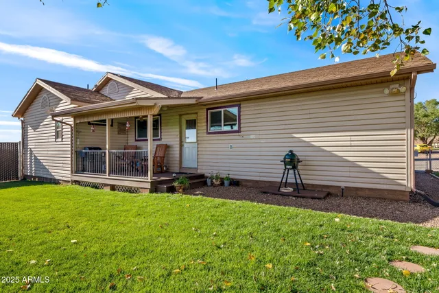 a view of a house with a yard and a garden