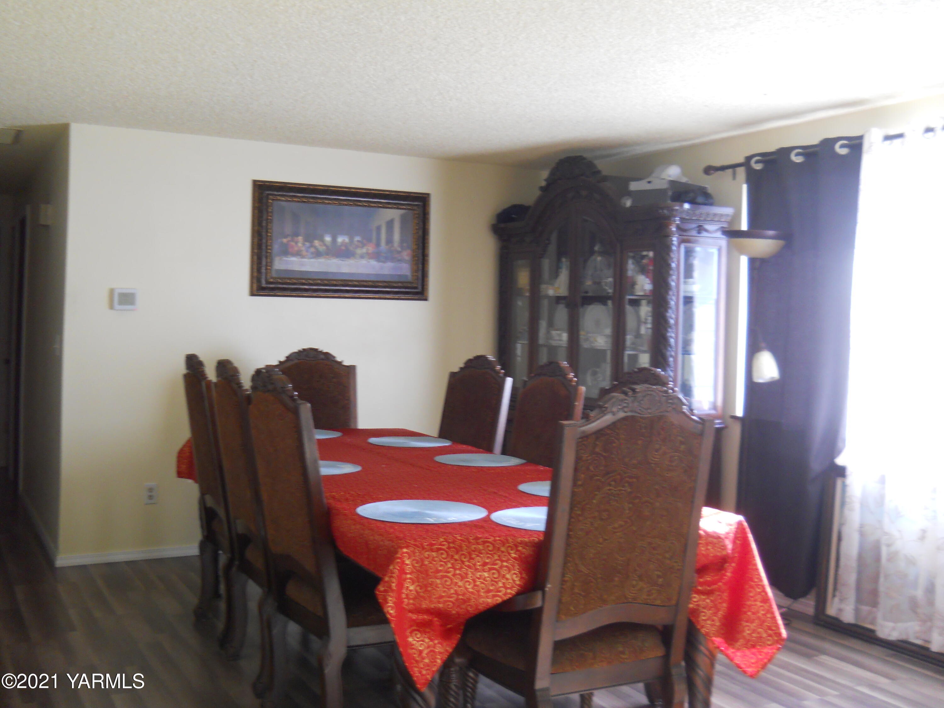 107 East Bonnieview Road Grandview, WA 98930 - Photo 3 of 24 a view of a dining room with furniture and wooden floor