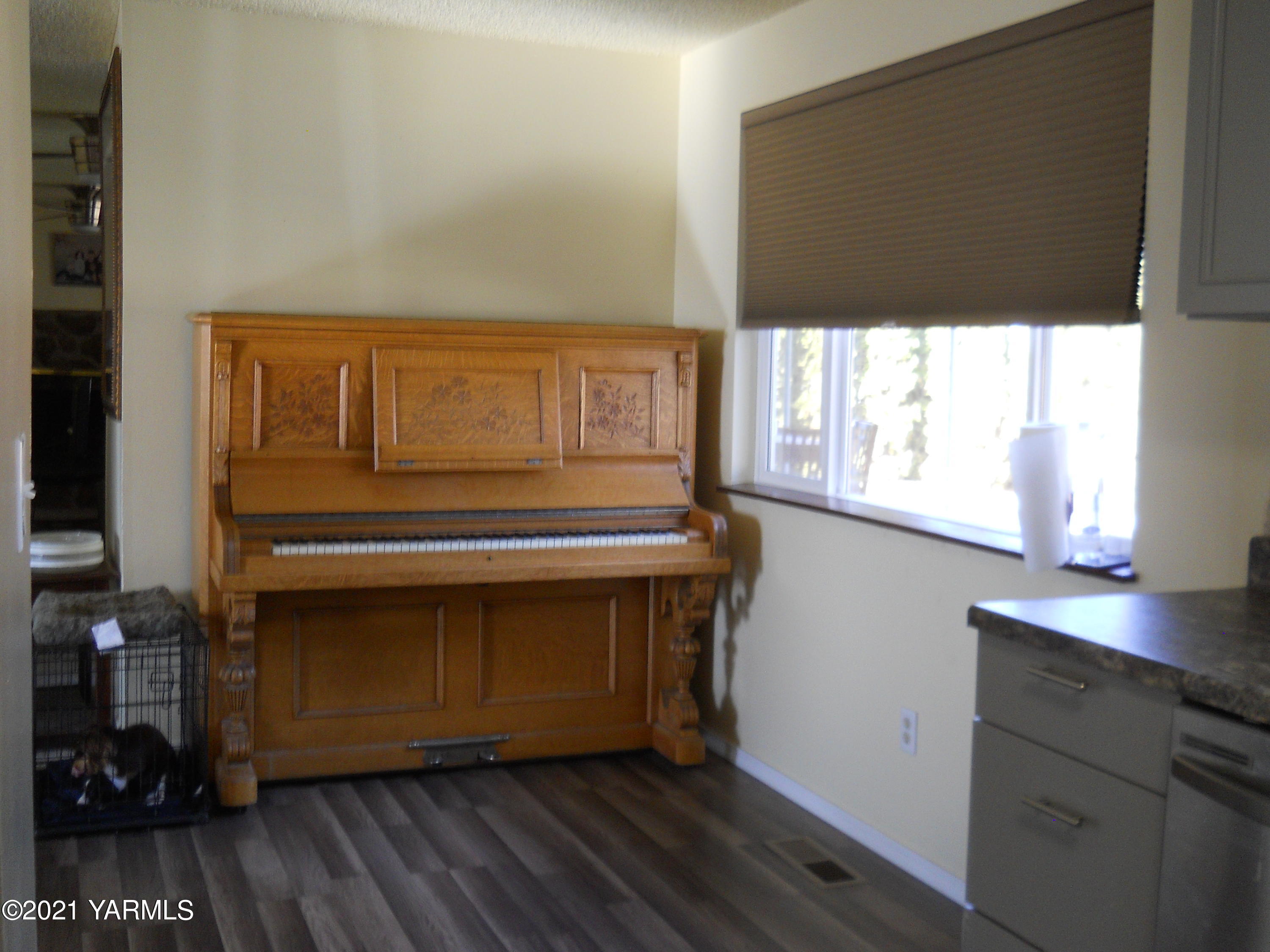 107 East Bonnieview Road Grandview, WA 98930 - Photo 6 of 24 a kitchen with a wooden floor and a window