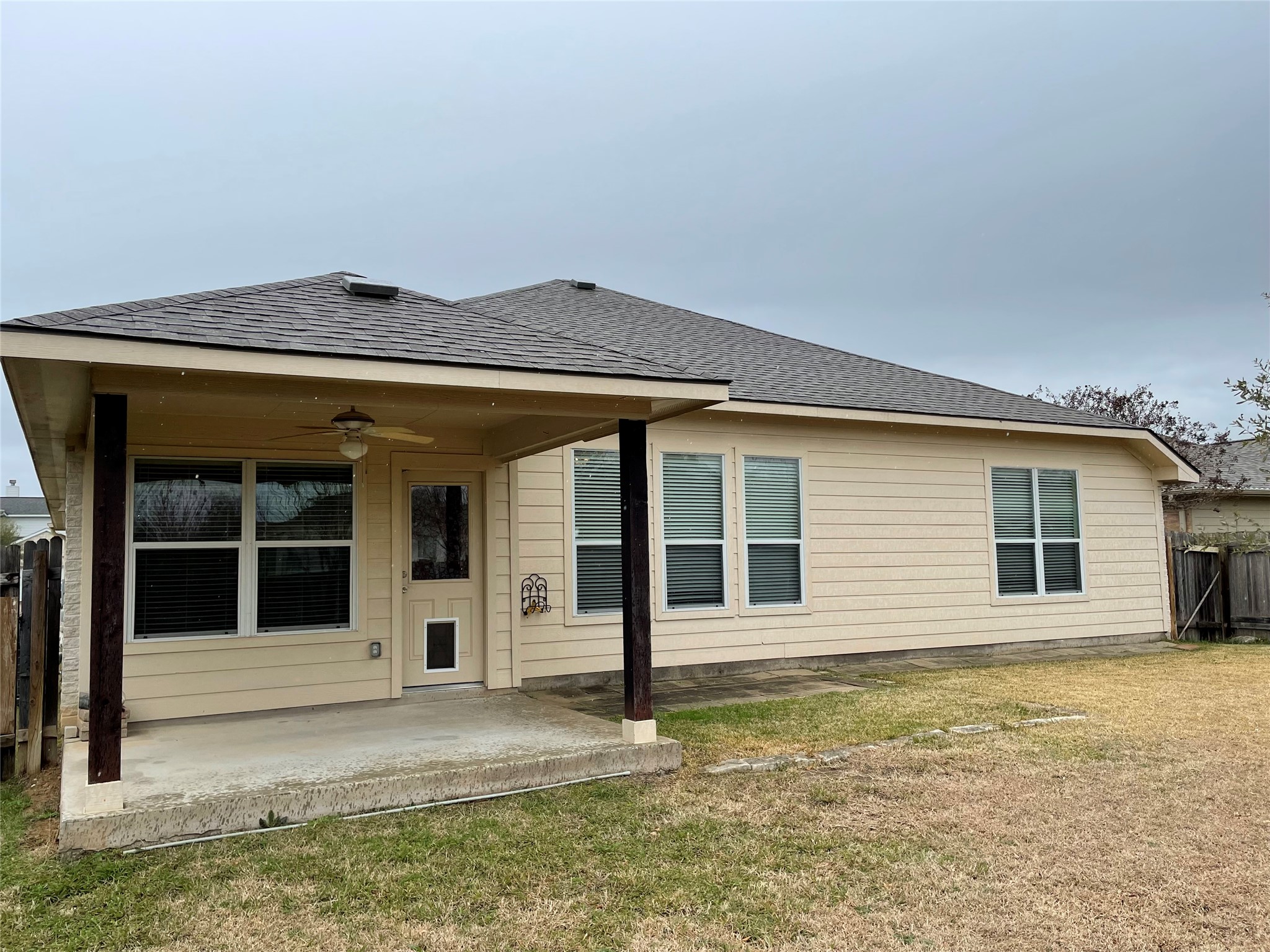 11713 Dunblane Way Austin, TX 78754 - Photo 22 of 22 Covered patio with a ceiling fan, featuring durable wooden support beams, concrete flooring, and direct access to the interior