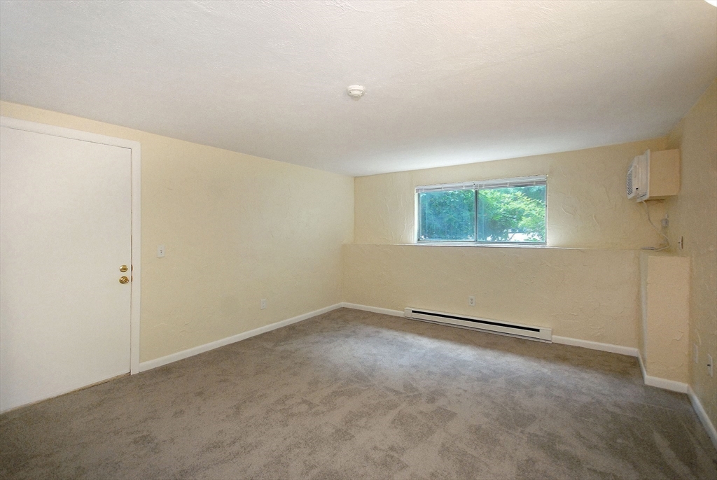 202 Swanson Road, Unit 515 Boxborough, MA 01719 - Photo 12 of 17 a view of an empty room with a window