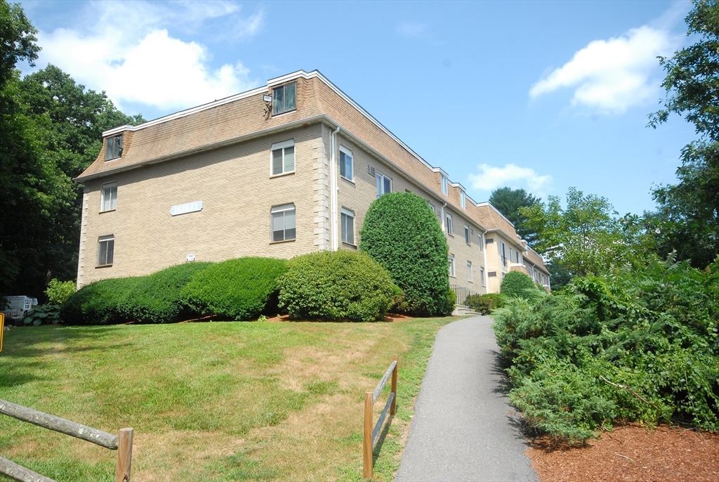 202 Swanson Road, Unit 515 Boxborough, MA 01719 - Photo 15 of 17 a view of a house with a yard