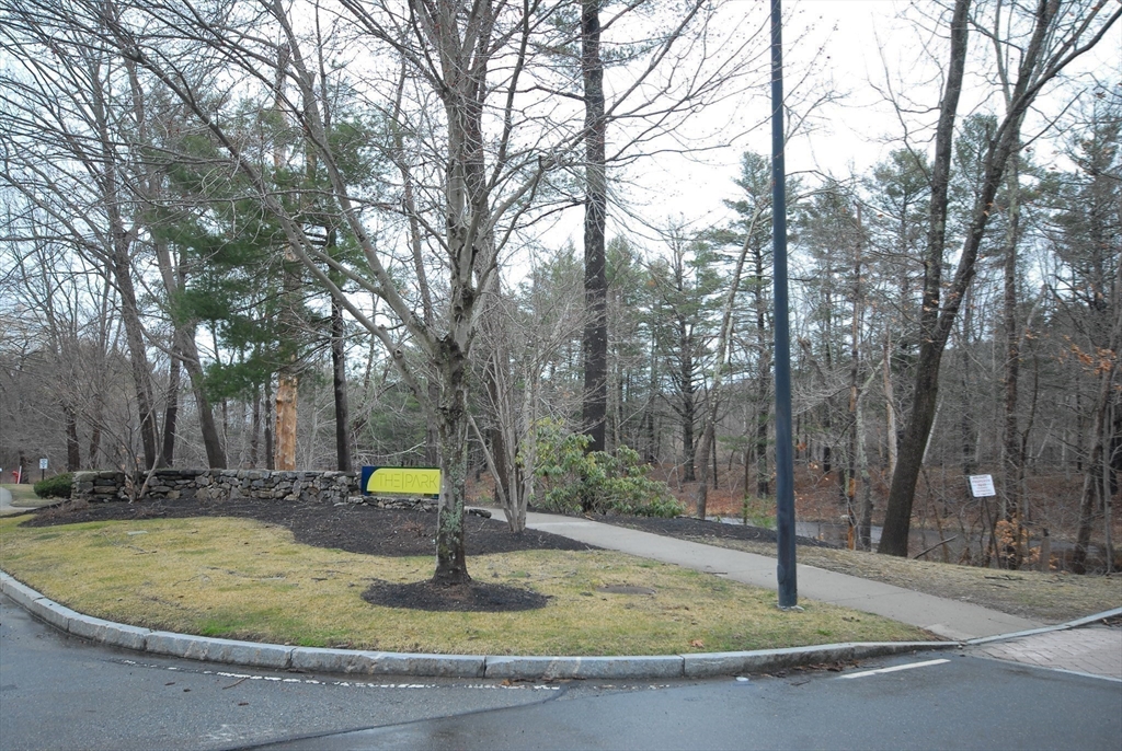 202 Swanson Road, Unit 515 Boxborough, MA 01719 - Photo 16 of 17 a swimming pool with lots of trees in the background