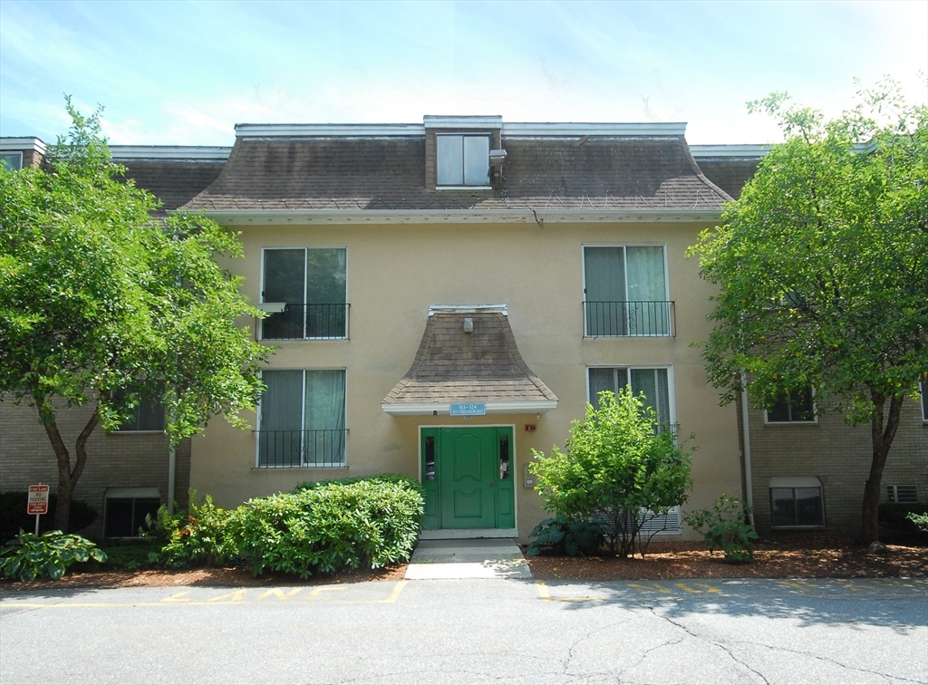 202 Swanson Road, Unit 515 Boxborough, MA 01719 - Photo 2 of 17 a front view of a house with garden