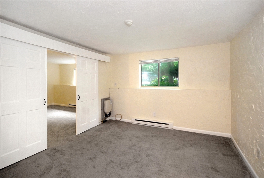 202 Swanson Road, Unit 515 Boxborough, MA 01719 - Photo 4 of 17 an empty room with windows