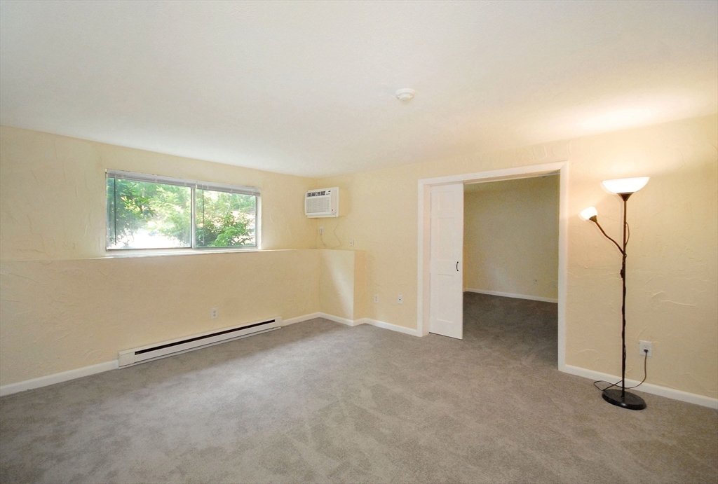 202 Swanson Road, Unit 515 Boxborough, MA 01719 - Photo 9 of 17 a view of an empty room with a window