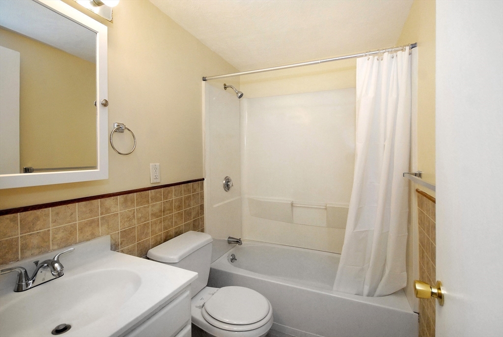 202 Swanson Road, Unit 515 Boxborough, MA 01719 - Photo 10 of 17 a bathroom with a sink toilet and shower
