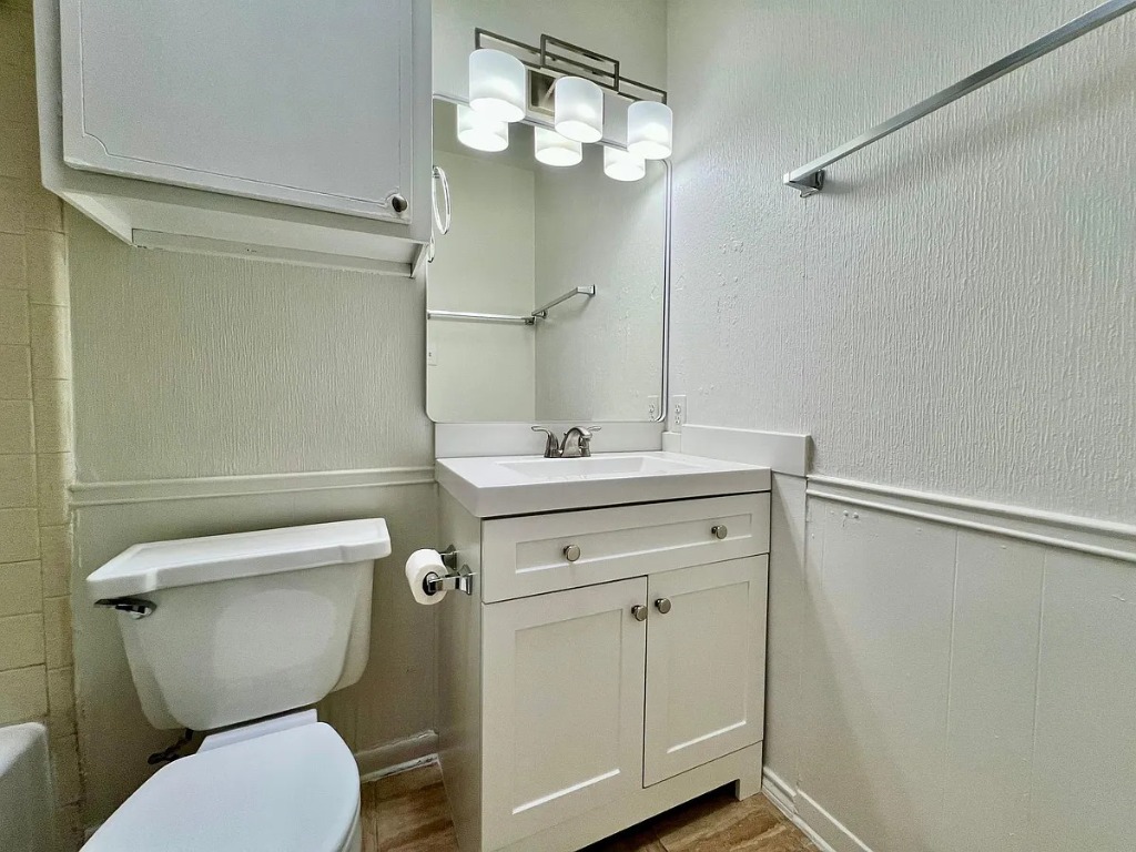 612 West 51st Street, Unit 101 Austin, TX 78751 - Photo 3 of 11 a bathroom with a toilet sink and mirror