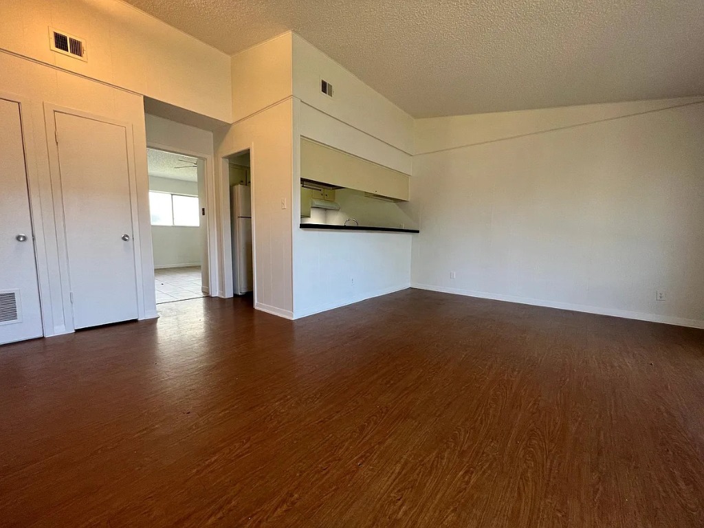612 West 51st Street, Unit 101 Austin, TX 78751 - Photo 4 of 11 a view of a room with wooden floor and brick wall