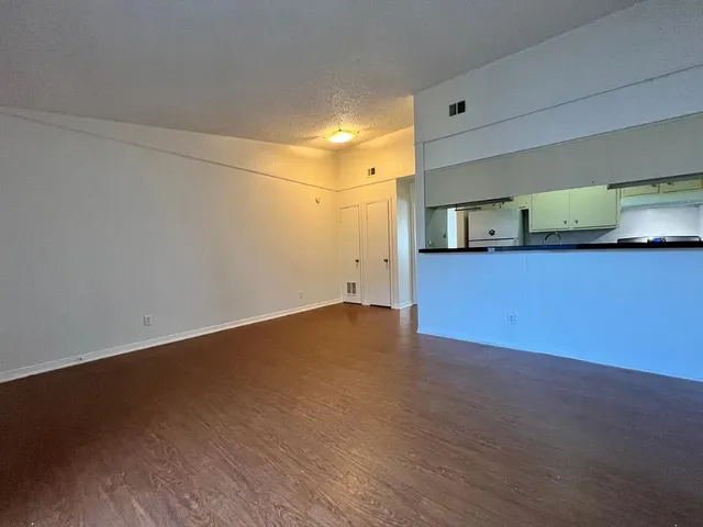 a view of a kitchen with wooden floor and sink