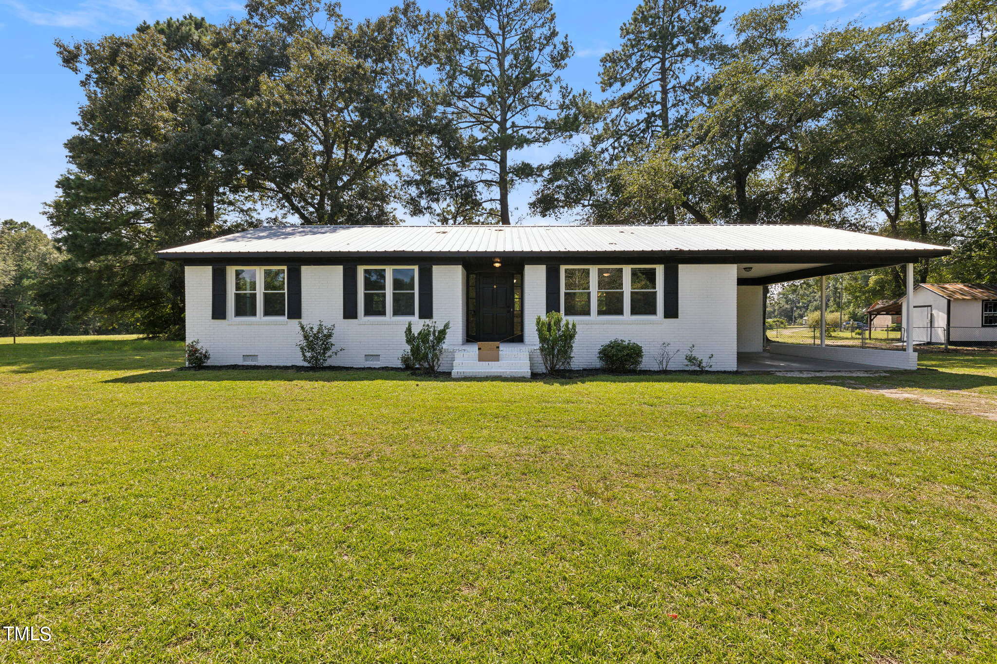 a front view of house with yard and outdoor seating