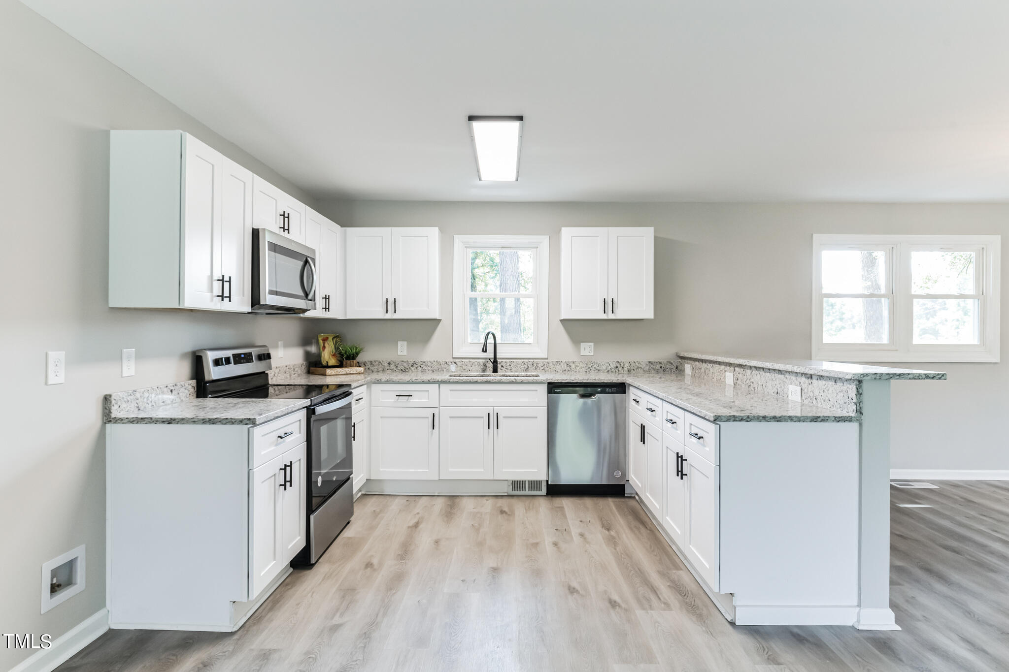 2395 Highway 210 Garland, NC 28441 - Photo 9 of 30 a kitchen with granite countertop white cabinets sink and stainless steel appliances