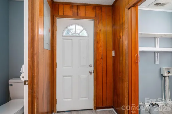 a view of front door with wooden door