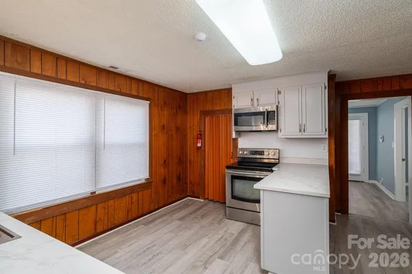 a kitchen with granite countertop stainless steel appliances and wooden cabinets