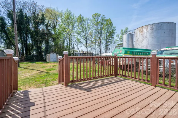 a view of a wooden deck with a yard