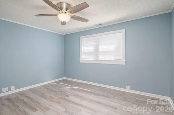 a view of a room with a ceiling fan and a window