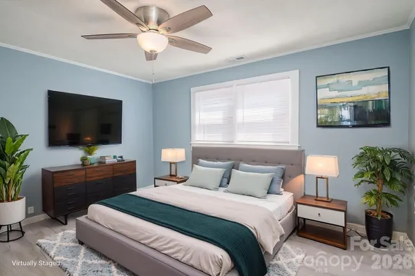 a bedroom with a bed and a flat screen tv