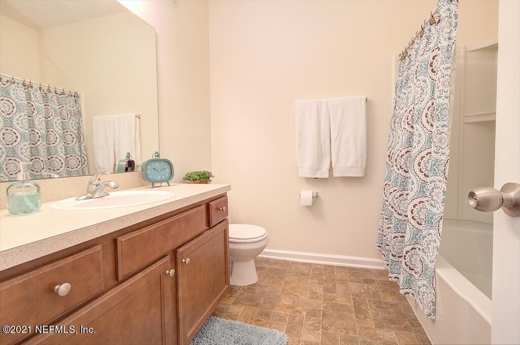 2211 Golden Lake Loop St. Augustine, FL 32084 - Photo 12 of 29 a bathroom with a sink a toilet and shower