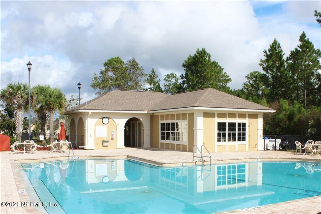 2211 Golden Lake Loop St. Augustine, FL 32084 - Photo 15 of 29 a view of a white house with a big yard and potted plants