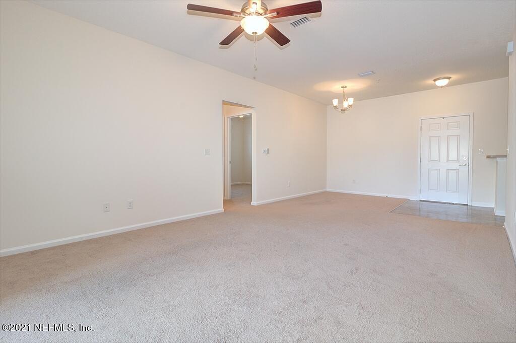 2211 Golden Lake Loop St. Augustine, FL 32084 - Photo 2 of 29 an empty room with fan and windows