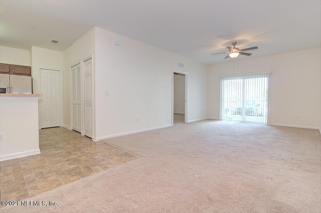 2211 Golden Lake Loop St. Augustine, FL 32084 - Photo 3 of 29 a view of a big room with windows and chandelier fan