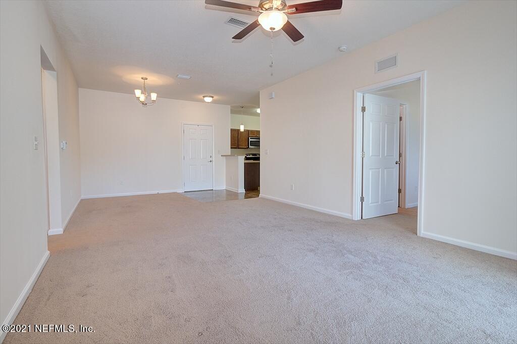 2211 Golden Lake Loop St. Augustine, FL 32084 - Photo 4 of 29 a view of a livingroom with a ceiling fan & kitchen space