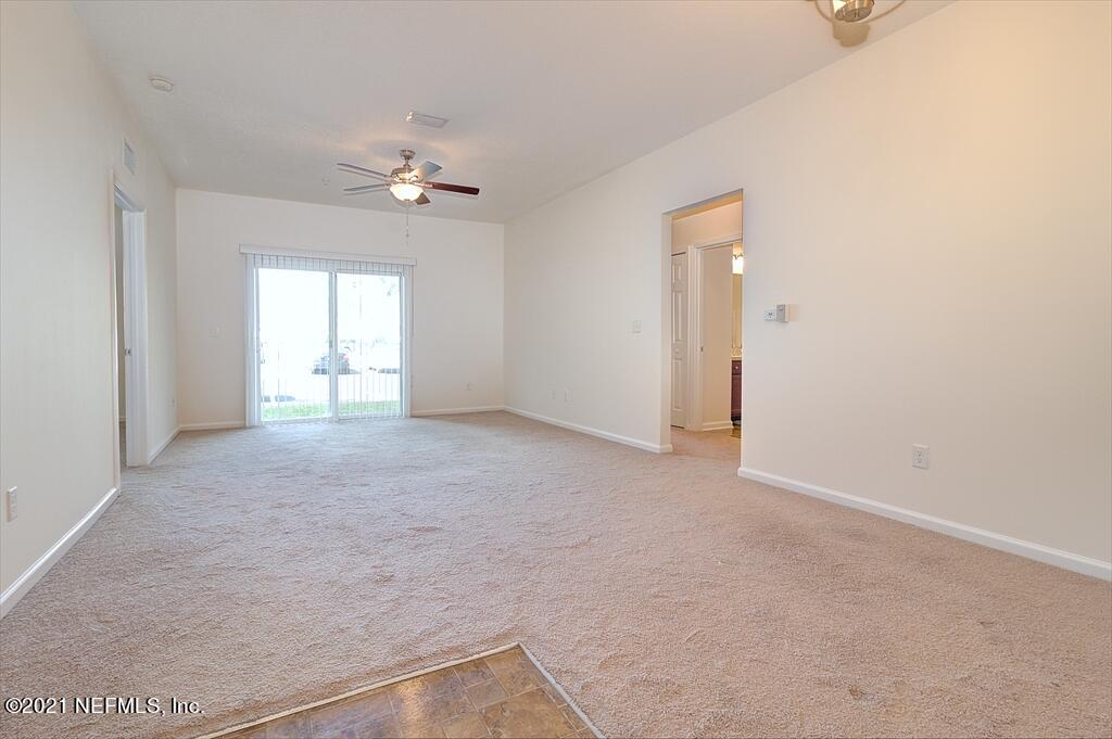 2211 Golden Lake Loop St. Augustine, FL 32084 - Photo 5 of 29 an empty room with a ceiling fan and a window