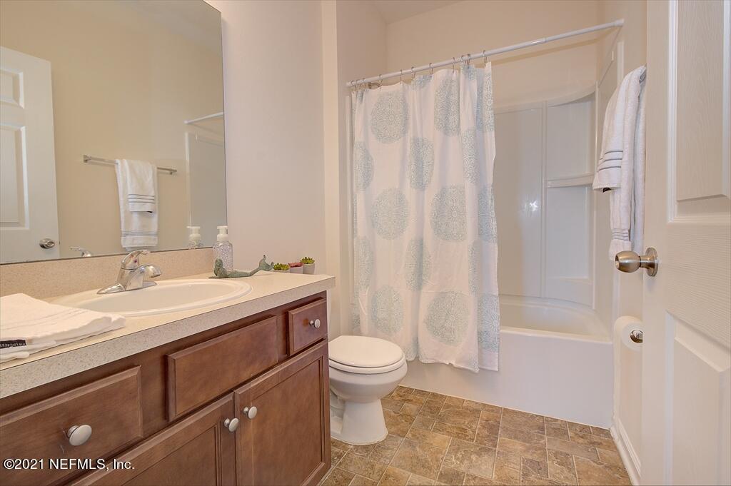 2211 Golden Lake Loop St. Augustine, FL 32084 - Photo 9 of 29 a bathroom with a granite countertop sink toilet and shower