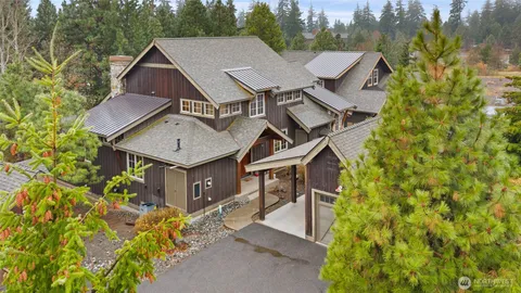 a aerial view of a house with a yard and fountain